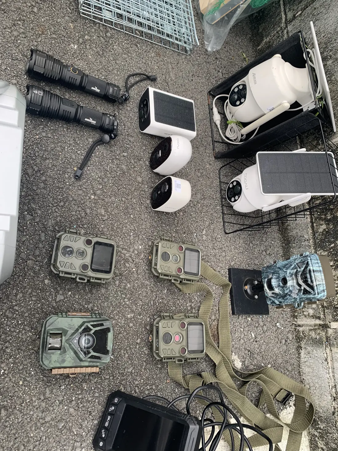 ライト、ソーラーカメラ、トレイルカメラ、モニターを並べた捜索用の機材